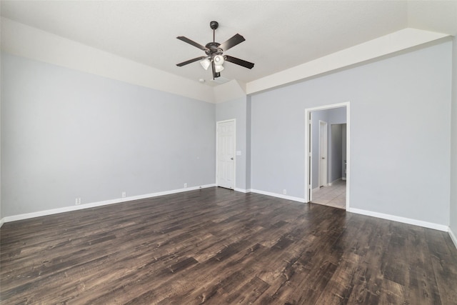 spare room with baseboards, lofted ceiling, wood finished floors, and a ceiling fan