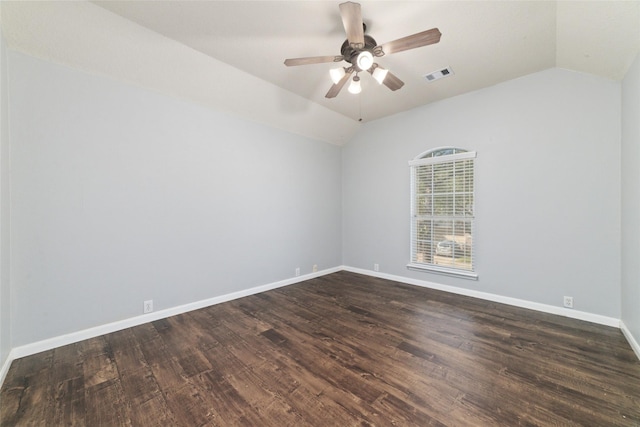 empty room featuring a ceiling fan, vaulted ceiling, baseboards, and dark wood-type flooring