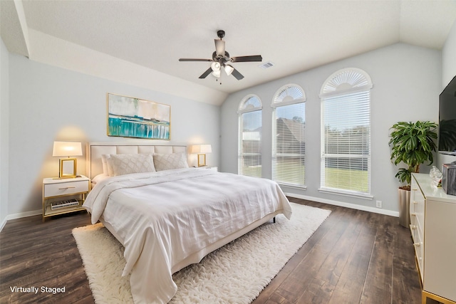 bedroom featuring dark wood-style floors, visible vents, baseboards, and vaulted ceiling