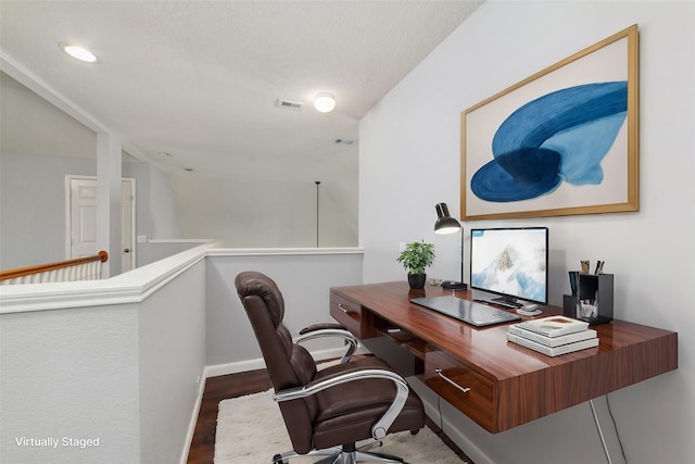 home office featuring visible vents, baseboards, and wood finished floors