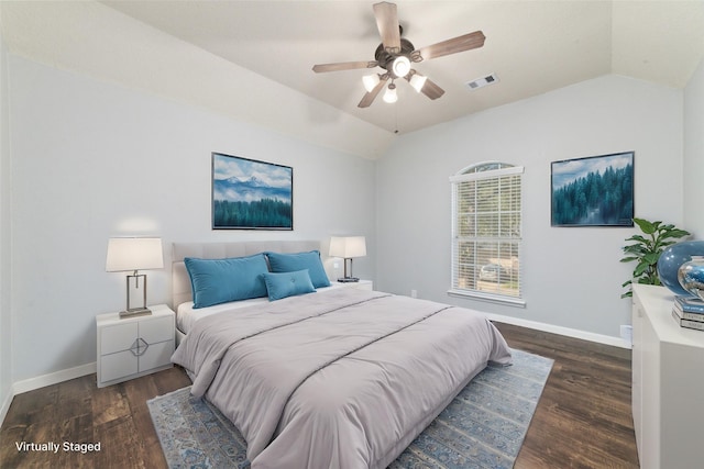 bedroom with baseboards, dark wood-type flooring, and lofted ceiling