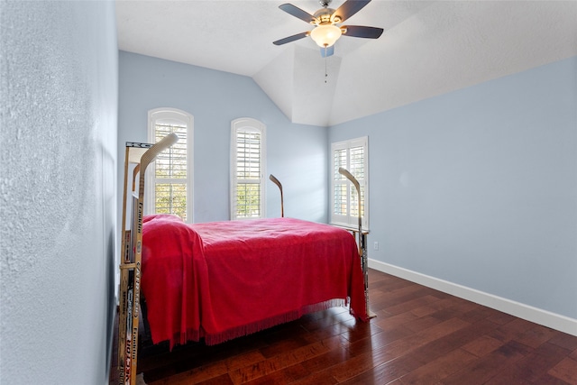 bedroom featuring baseboards, lofted ceiling, hardwood / wood-style floors, and a ceiling fan