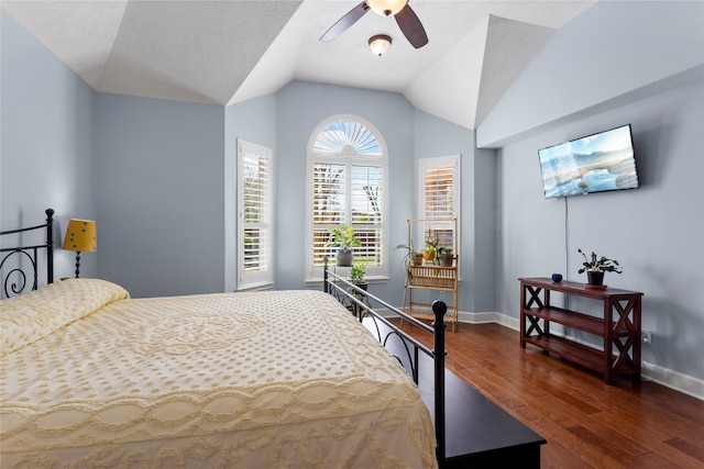 bedroom featuring ceiling fan, baseboards, lofted ceiling, and wood finished floors