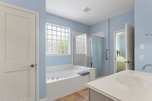 ensuite bathroom featuring vanity, a tub with jets, visible vents, curtained shower, and tile patterned floors