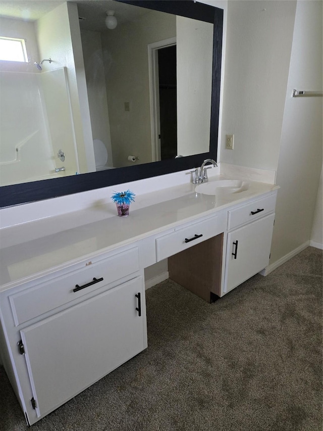 full bathroom featuring walk in shower, vanity, and carpet flooring