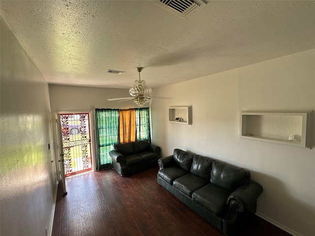 living area with visible vents, a textured ceiling, a ceiling fan, and hardwood / wood-style flooring