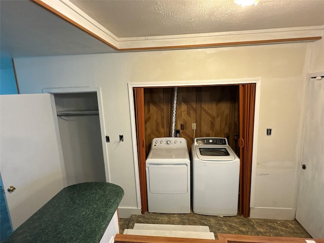 laundry area with laundry area, washer and dryer, and a textured ceiling