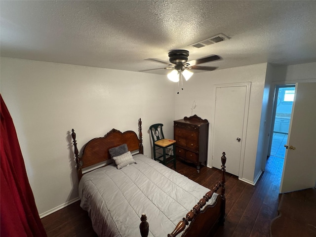 bedroom featuring visible vents, a textured ceiling, ceiling fan, and hardwood / wood-style floors