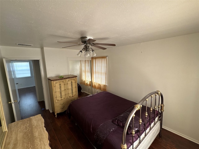 bedroom featuring visible vents, wood-type flooring, and a textured ceiling