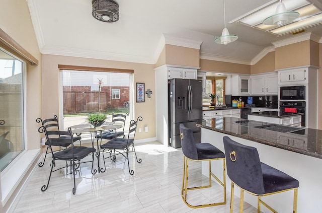 kitchen featuring decorative backsplash, black appliances, white cabinets, and crown molding