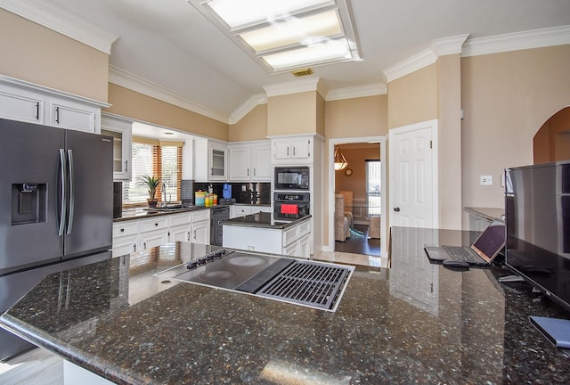 kitchen featuring black appliances, a sink, white cabinets, crown molding, and glass insert cabinets