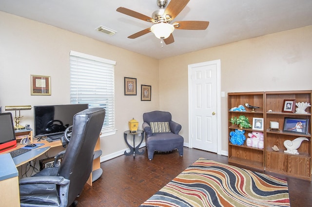 office area with a ceiling fan, wood finished floors, visible vents, and baseboards