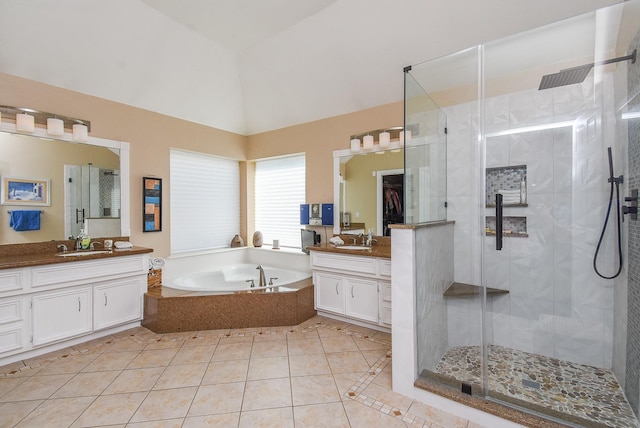 bathroom with tile patterned floors, two vanities, a sink, a shower stall, and a bath