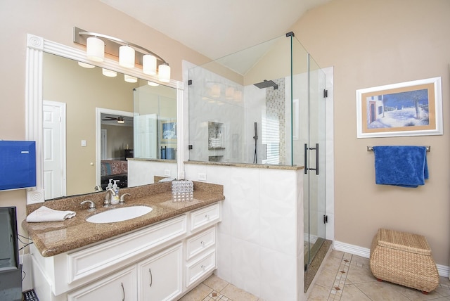 ensuite bathroom with lofted ceiling, a stall shower, ensuite bathroom, tile patterned floors, and vanity