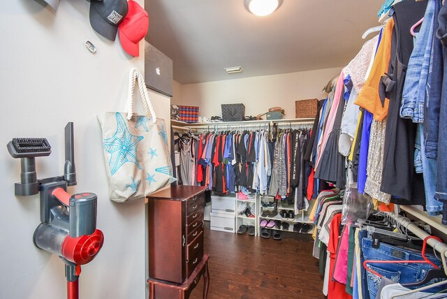 spacious closet with dark wood-style flooring