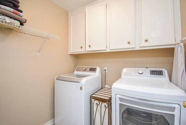 laundry area with cabinet space and independent washer and dryer