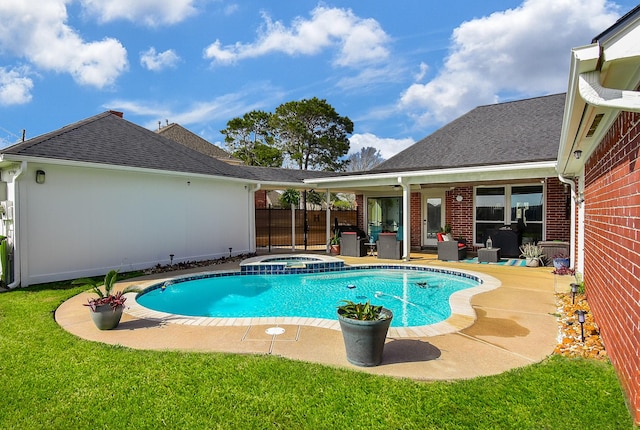 view of swimming pool with a yard, a patio, and a pool with connected hot tub