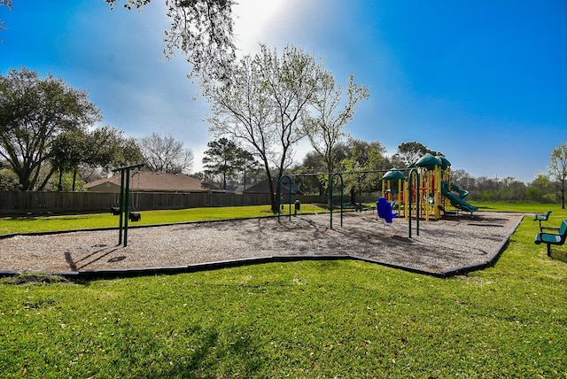 community playground with a yard and fence