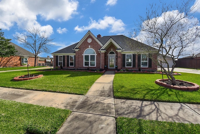 view of front of home with a front lawn, brick siding, roof with shingles, and a chimney