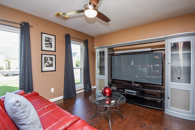 living room with visible vents, baseboards, a ceiling fan, and hardwood / wood-style flooring