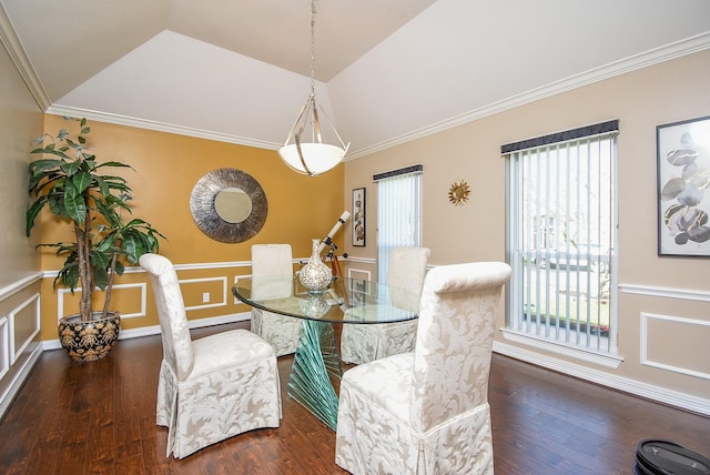 dining room featuring wood finished floors, vaulted ceiling, wainscoting, crown molding, and a decorative wall