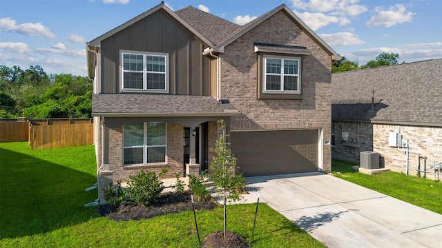 view of front facade with central AC, fence, board and batten siding, concrete driveway, and a front yard