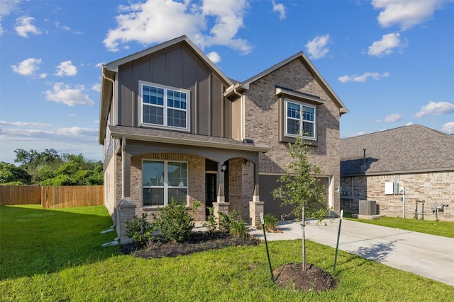 craftsman-style home with a front yard, fence, concrete driveway, a garage, and board and batten siding