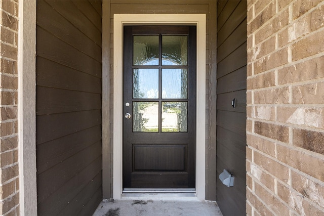 property entrance with brick siding