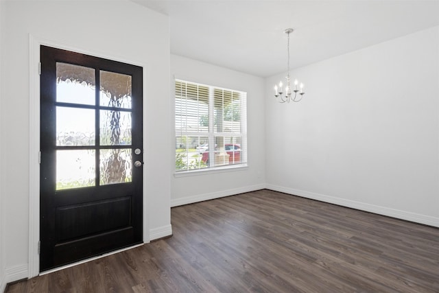 foyer with baseboards, a notable chandelier, and dark wood-style flooring