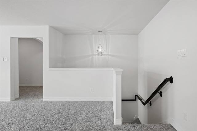 stairs featuring baseboards and carpet floors