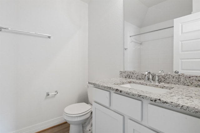 full bath with toilet, wood finished floors, baseboards, walk in shower, and vanity