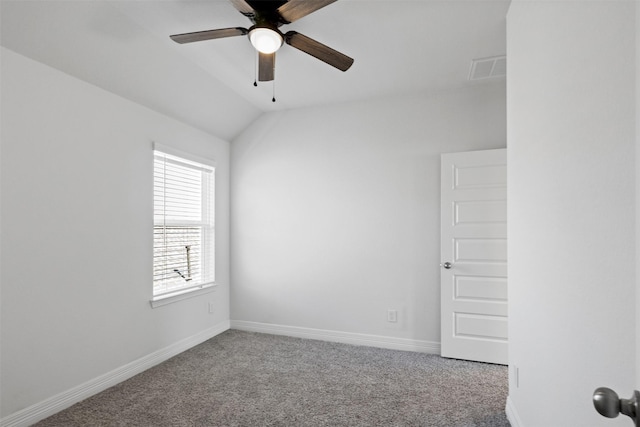 spare room with a ceiling fan, lofted ceiling, carpet, and baseboards