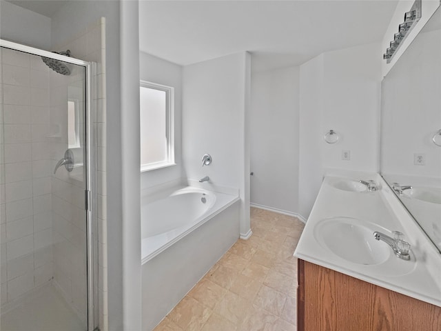 bathroom featuring a bath, a shower stall, double vanity, and a sink