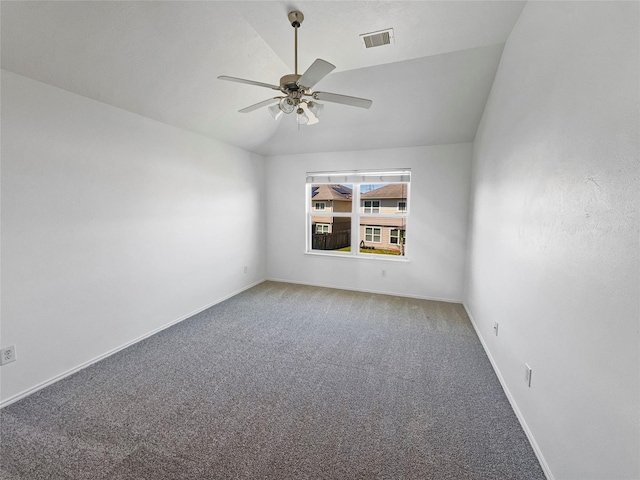 unfurnished room featuring carpet, baseboards, visible vents, lofted ceiling, and ceiling fan