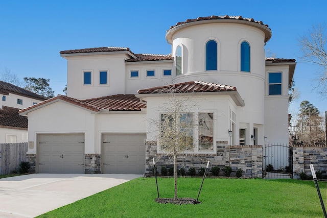 mediterranean / spanish-style house with fence, stucco siding, a front lawn, stone siding, and a tile roof