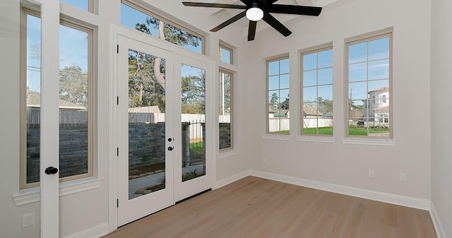 doorway to outside with a wealth of natural light, french doors, wood finished floors, and ceiling fan