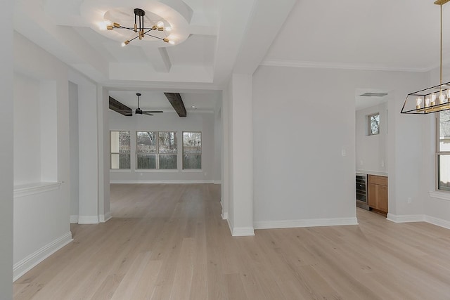 unfurnished room with baseboards, beam ceiling, light wood-style floors, and a chandelier