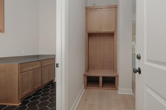 mudroom with baseboards and wood finished floors