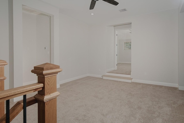 spare room with visible vents, a ceiling fan, recessed lighting, baseboards, and light colored carpet