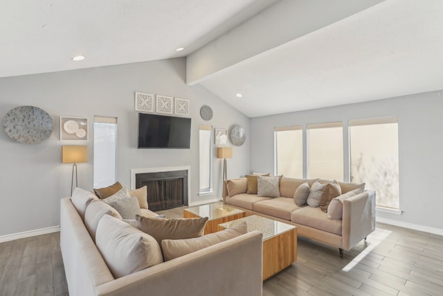 living area featuring wood finished floors, baseboards, lofted ceiling, a fireplace, and recessed lighting