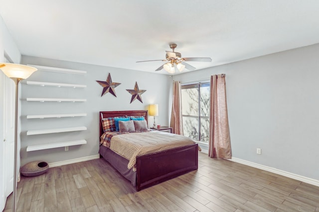 bedroom with baseboards, light wood-style floors, and ceiling fan