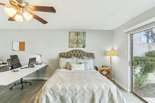 bedroom featuring a ceiling fan, access to outside, wood finished floors, and baseboards