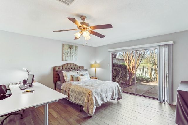 bedroom with a ceiling fan, access to exterior, wood finished floors, and visible vents