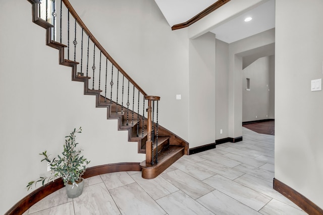 staircase with recessed lighting, baseboards, and beam ceiling