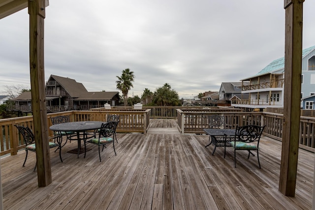 wooden deck featuring a residential view and outdoor dining space