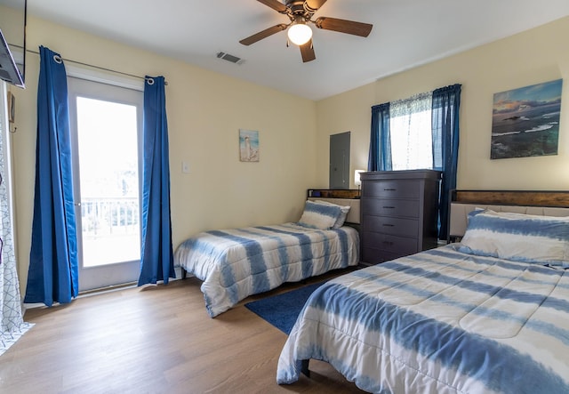 bedroom featuring a ceiling fan, wood finished floors, and visible vents