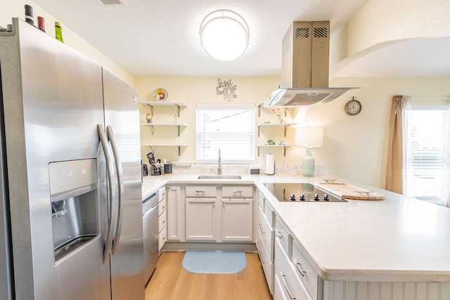 kitchen featuring a sink, open shelves, stainless steel appliances, a peninsula, and island range hood