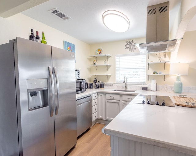 kitchen featuring island exhaust hood, open shelves, appliances with stainless steel finishes, and visible vents