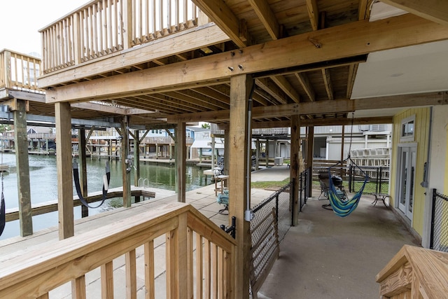 dock area with boat lift and a water view