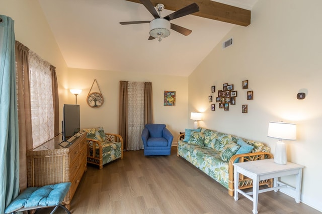 living area featuring visible vents, lofted ceiling with beams, ceiling fan, and wood finished floors